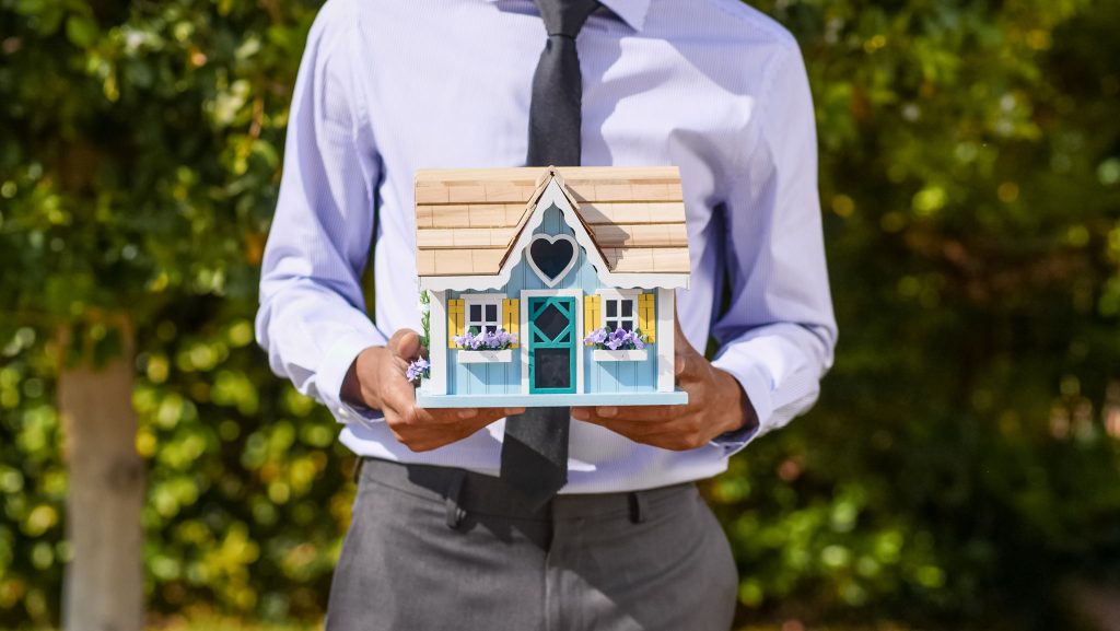 man holding house