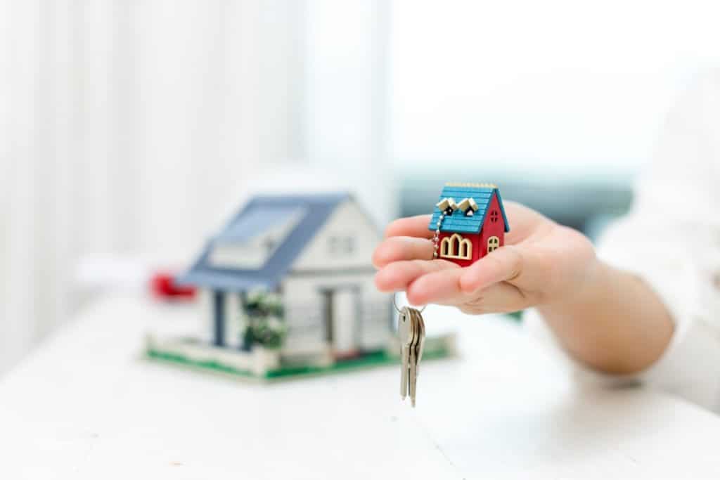 Real estate agent with house model and keys